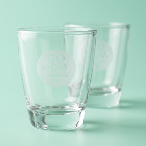Close-up of the engraved Go Now logo on a shot glass