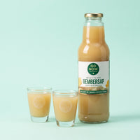Twee Go Now shotglazen met gembersap naast een fles Pure Gembersap 750ml