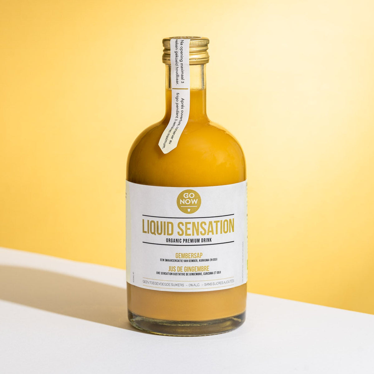Fles Go Now Liquid Sensation 500ml tegen een gele achtergrond
